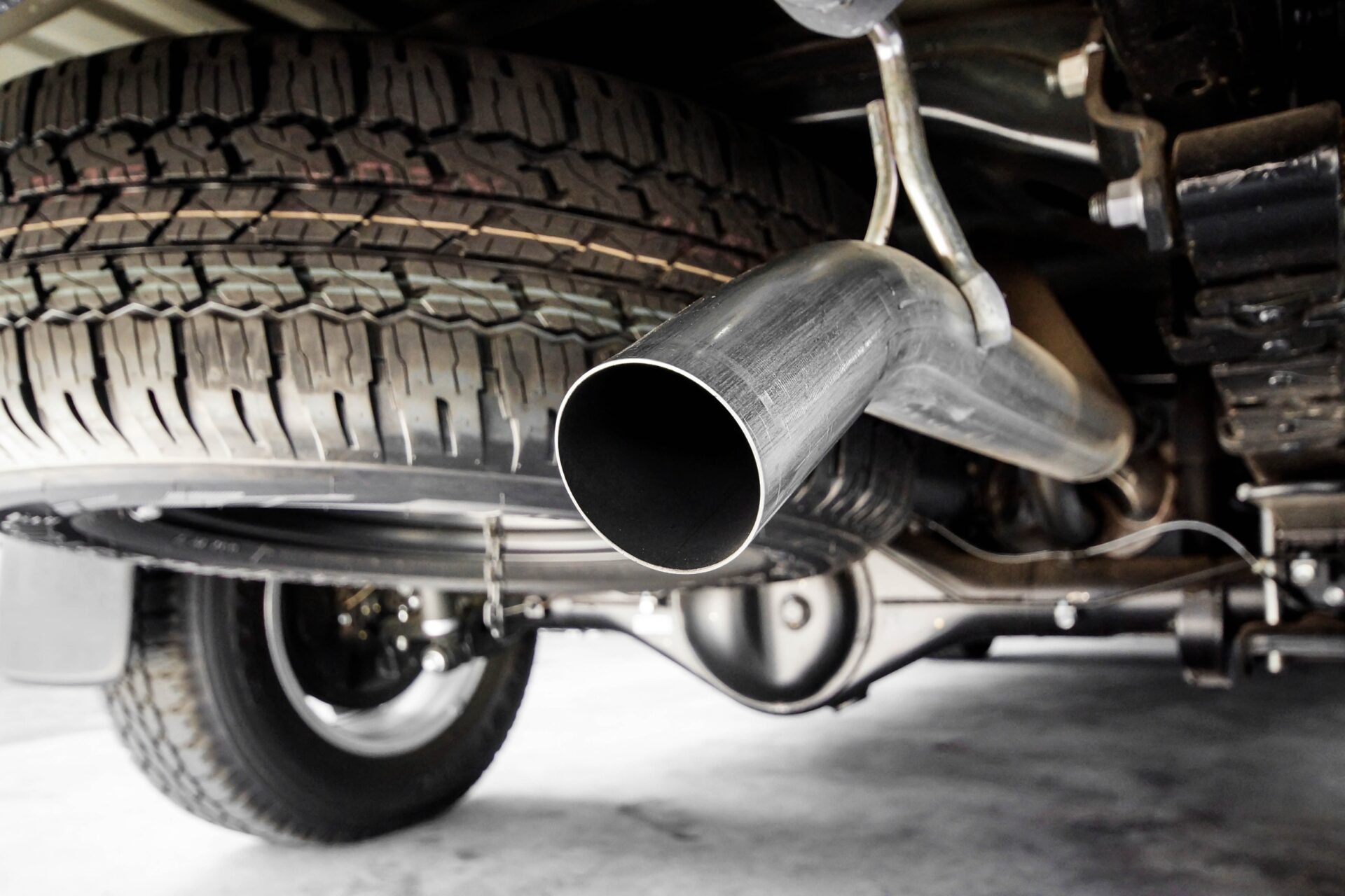 Close up of exhaust pipes of a modern car in the garage.