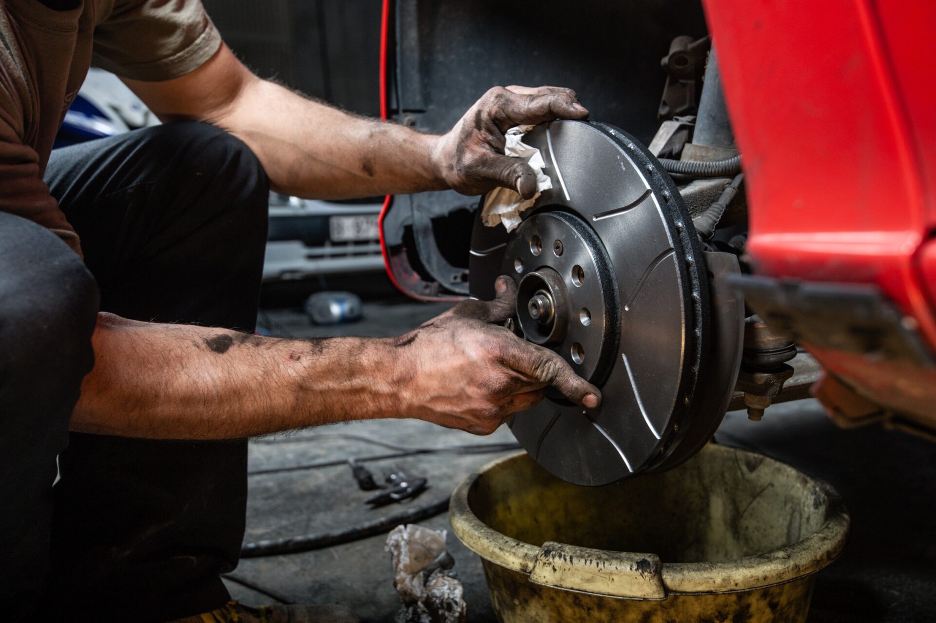 Close up of a man's hands placing some brake discs