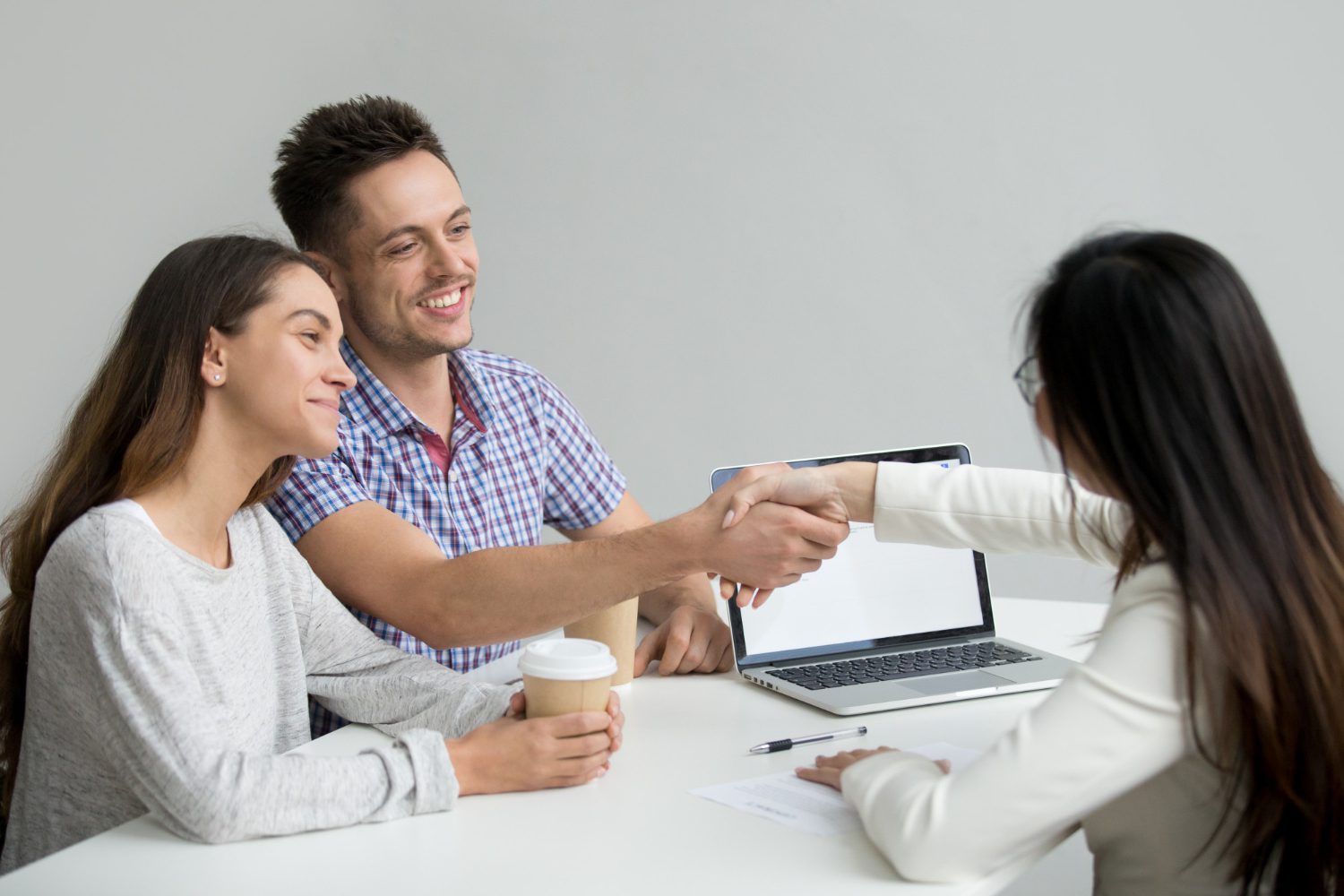 Happy couple greeting financial consultant